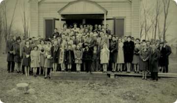 A black and white photo of churchgoers from the past