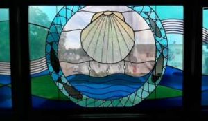 Stained glass with a clam and other decorative elements